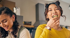 Group of friends enjoying meal in kitchen