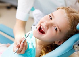 girl smiling in dental chair