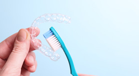 Patient cleaning clear aligner with toothbrush