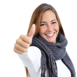 smiling young woman giving thumbs up