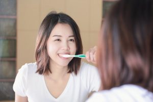 Woman brushing her teeth.