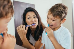 parent and child brushing their teeth