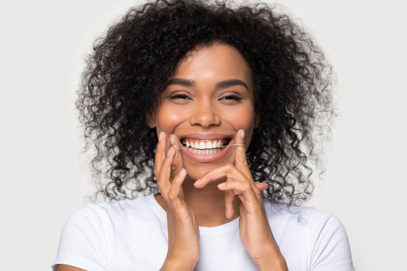 girl flossing her teeth