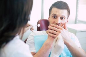 man looking scared at dentist 