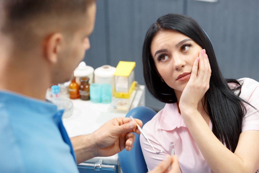 Woman visiting the dentist for emergency dentistry.