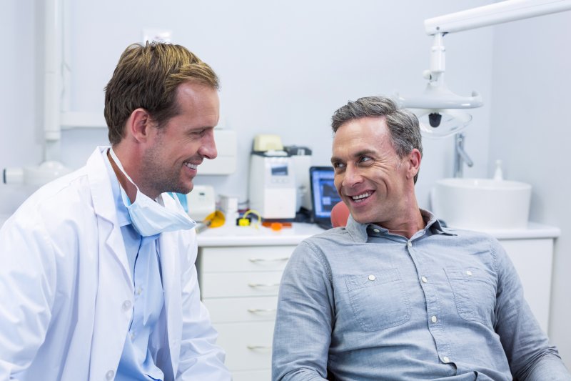 dentist talking to patient about dental implants