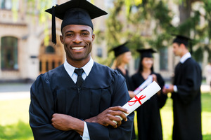 College graduate smiling and holding his diploma