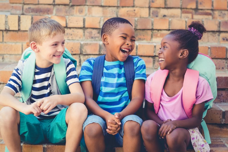 Kids sitting together on a staircase