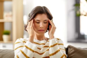 Stressed woman with her hands on her temples