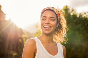 Woman smiling with straight, beautiful teeth.